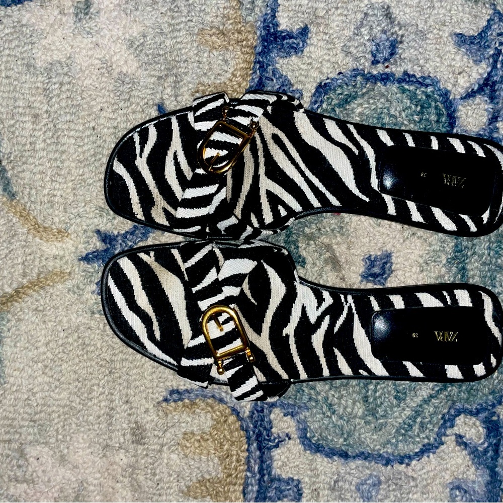 Zara zebra sandals with gold accents. The material is some type of fabric.